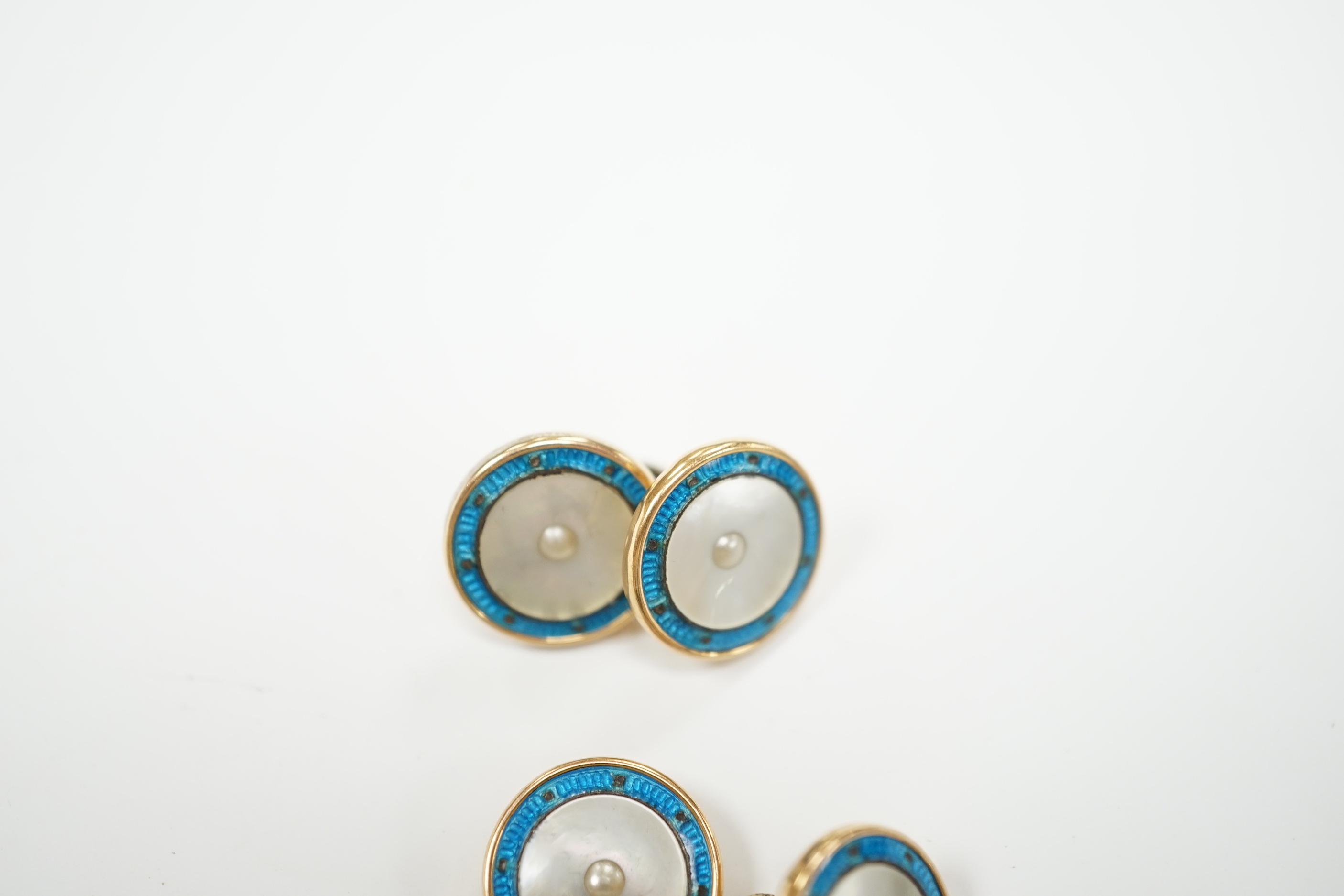 A pair of 9ct, mother of pearl and enamelled circular cufflinks, one link detached, 13mm, gross weight 6.5 grams.